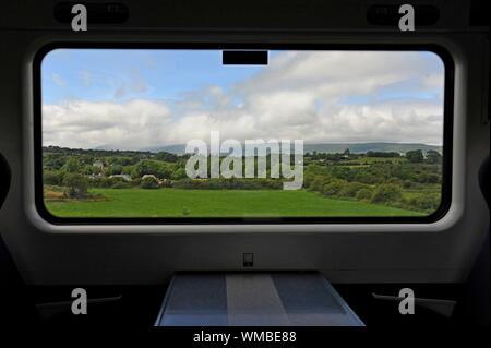 View through the window of an Irish Railway carriage in Co Kerry, Republic of Ireland Stock Photo