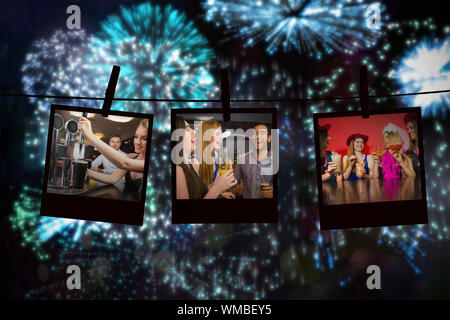 Attractive friends at a hen night drinking cocktails against colourful fireworks exploding on black background Stock Photo