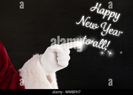 Santa claus points at something against black Stock Photo