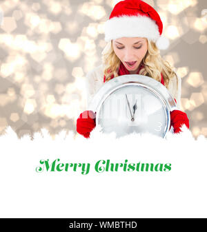 happy festive blonde with clock against merry christmas Stock Photo