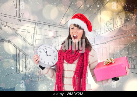 Yelling brunette holding a clock and gift against light glowing dots design pattern Stock Photo