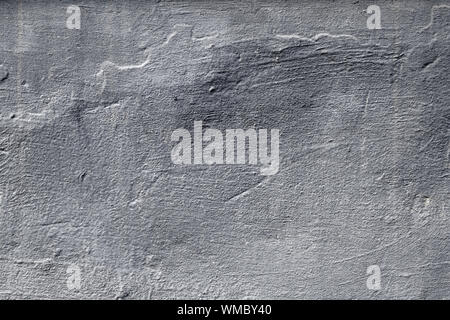 Dark gray concrete wall. Grunge background. Abstract pattern of messy painted wall. Urban dirty rough stone surface, texture. Grey cement rock effect. Stock Photo