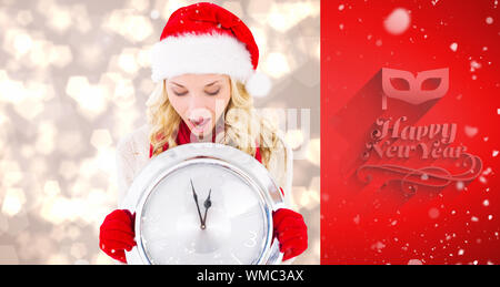 happy festive blonde with clock against red vignette Stock Photo