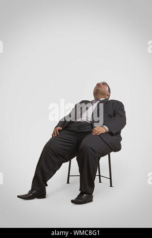 Full body shot of overweight businessman in suit Stock Photo - Alamy