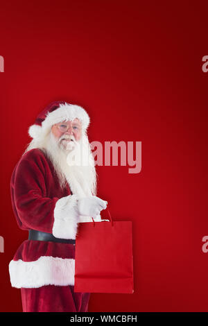 Santa carries his red bag against world map with compass showing europe ...