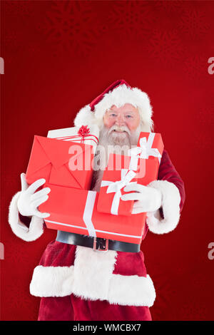 Santa carries a few presents against red background Stock Photo - Alamy