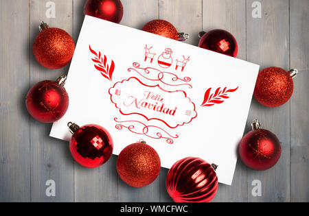Feliz navidad message against pale grey wooden planks Stock Photo
