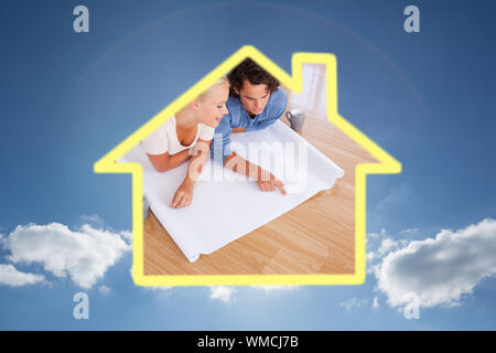 Cute man showing a point on a plan to his fiance against cloudy sky with sunshine Stock Photo
