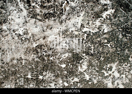 Concrete white wall with the dominance of black in the form of a figured motley pattern. Stock Photo