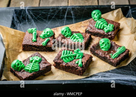 Halloween style party sweet - brownie with green skeleton and bones Stock Photo