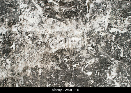 Concrete white wall with the dominance of black in the form of a figured motley pattern. Stock Photo