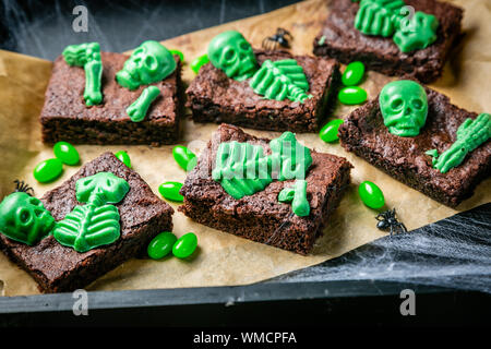 Halloween style party sweet - brownie with green skeleton and bones Stock Photo