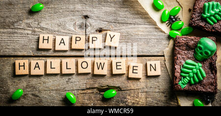 Halloween style party sweet - brownie with green skeleton and bones Stock Photo