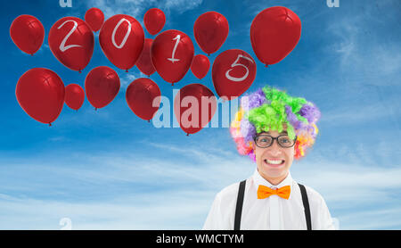 Geek in afro wig against blue sky Stock Photo