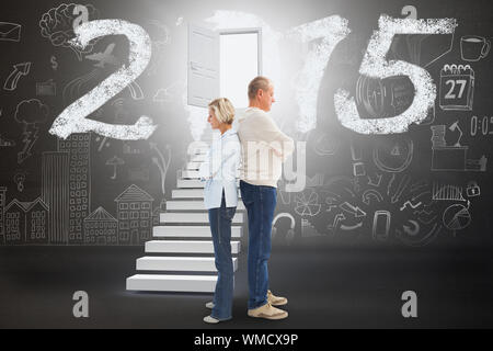 Unhappy couple not speaking to each other  against black Stock Photo