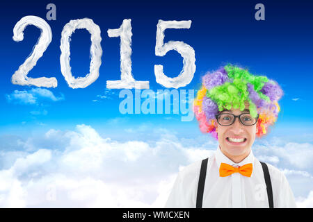 Geek in afro wig against bright blue sky over clouds Stock Photo