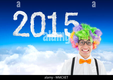 Geek in afro wig against blue sky over clouds Stock Photo