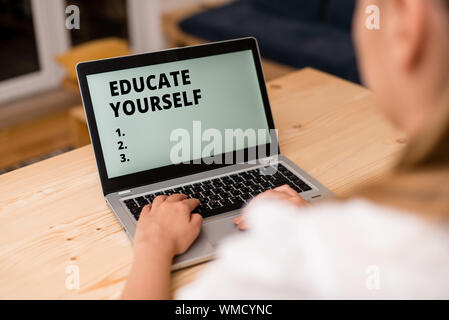 Conceptual hand writing showing Educate Yourself. Concept meaning prepare oneself or someone in a particular area or subject woman with laptop smartph Stock Photo