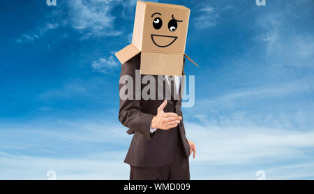 Anonymous businessman offering his hand against blue sky Stock Photo