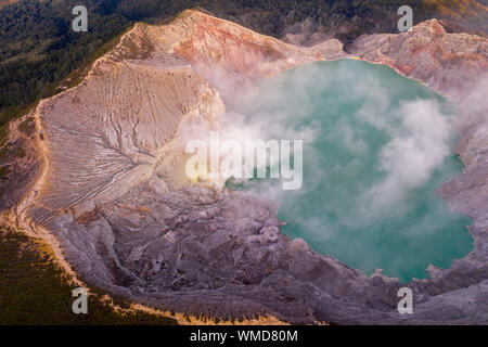 Kaweh Ijen volcano crater in Eastern Java, Indonesia billowing sulphur gas at sunrise Stock Photo