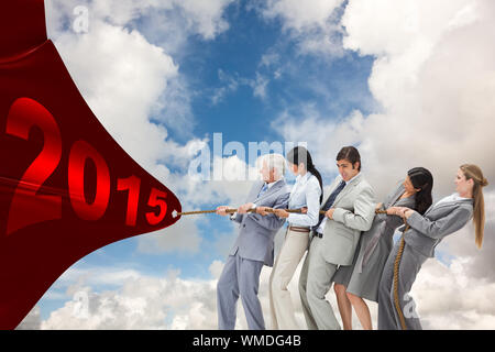 Business people pulling a rope against blue sky with white clouds Stock Photo