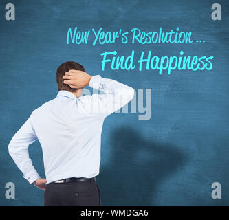 Thinking businessman scratching head against blue chalkboard Stock Photo
