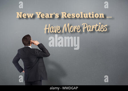 Thinking businessman scratching head against grey vignette Stock Photo