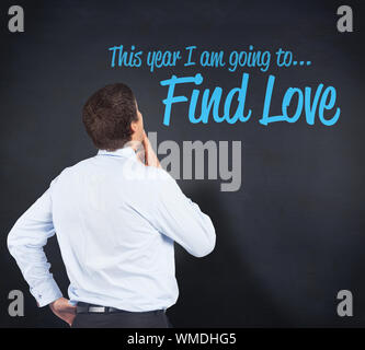 Thinking businessman touching his chin against blackboard Stock Photo