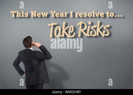 Thinking businessman scratching head against grey vignette Stock Photo