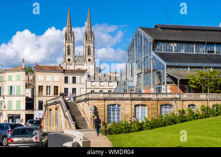 Niort, France - May 11, 2019: Steeples of the Saint-Andre church and covered market hall of Baltard style in old town of Niort, Deux-Sevres, France Stock Photo