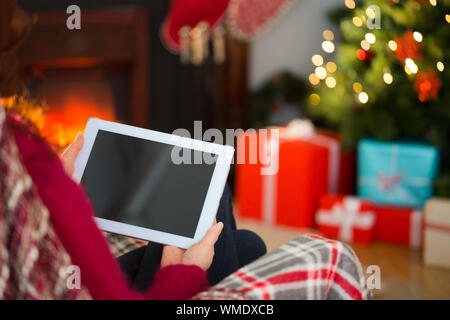 Redhead using tablet computer at christmas at home in the living room Stock Photo