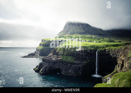 Gasadalur village and Beautiful waterfall. Vagar, Faroe Islands, Denmark Stock Photo