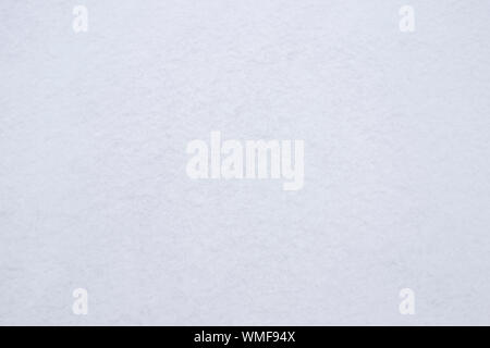 White background with a bluish tinge of soft snow surface. Stock Photo