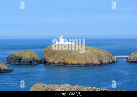 Strumble Head Lighthouse stands on Ynys Meicel also known as Strumble Head Pencaer Fishguard Pembrokeshire Coast National Park Wales Cymru UK Stock Photo