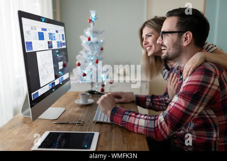 Young couple of designers working on computer Stock Photo