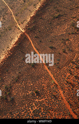 A 4WD track runs over a sand dune in the remote Simpson Desert, in outback Queensland Australia Stock Photo