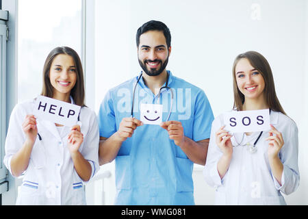 Health Care. Medical Team Holding Inscriptions For Help at the Hospital All Together. Doctor's Team. Stock Photo