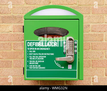 Automated External Defibrillator Mounted on the Wall of a Village Hall, Stanford in the Vale, Oxfordshire, United Kingdom Stock Photo