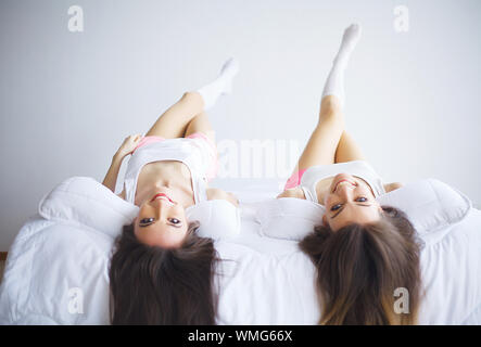Two stunning women talking on phones with their hair ...