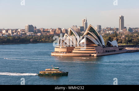 Ferry on Sydney Harbour with Opera House in the background. Blue Sky. Harbor cruise. Stock Photo