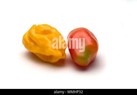One yellow ripe  pepper and one  red ripe pepper isolated on white background. Selective focus. Stock Photo