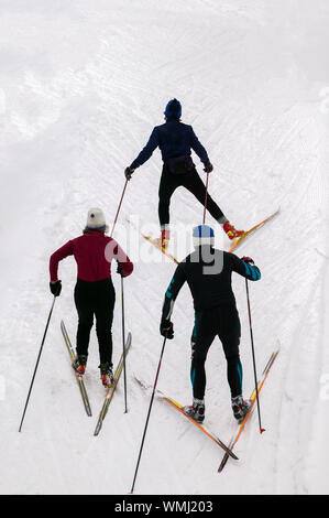 Looking down on three cross country skiers. Stock Photo