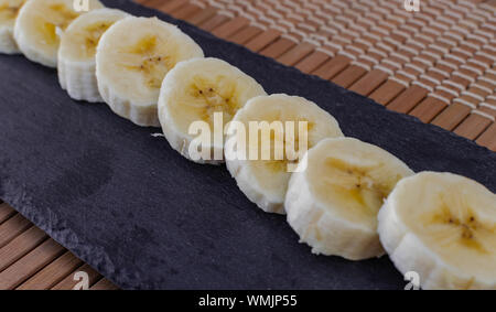 Sliced banana on black surface Stock Photo