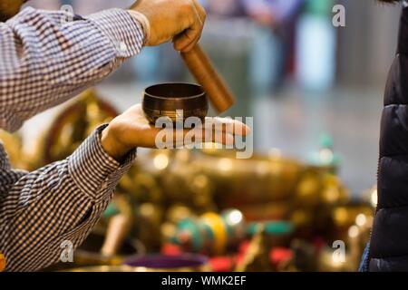Cropped Image Of Man Playing Tibetan Singing Bowl