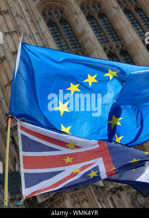 London, UK. 4th September 2019. European Union flag with golden stars in a circle and Union Jack flying together in front of the Houses of Parliament, London, at an anti-brexit protest. Credit: Joe Kuis / Alamy News Stock Photo