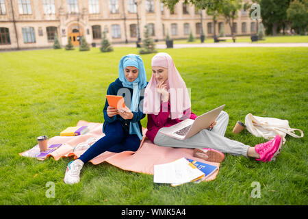 Muslim women smiling having video chat with friend Stock Photo