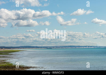 Worthing seafront during low tide on a sunny day looking along the coast towards Brighton. Stock Photo