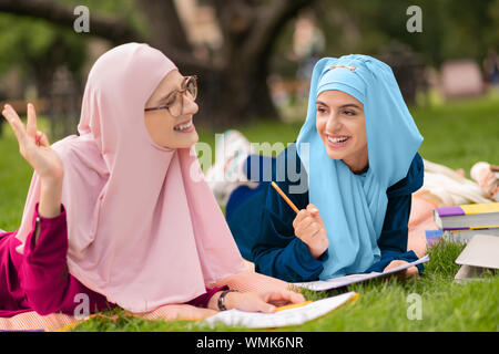 Cheerful muslim students feeling amazing while studying together Stock Photo