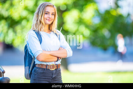Female high school student with schoolbag. Portrait of attractive young blonde girl. Stock Photo