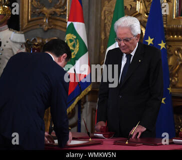 (190905) -- ROME, Sept. 5, 2019 (Xinhua) -- Italian Prime Minister Giuseppe Conte (L) and Italian President Sergio Mattarella attend a swearing-in ceremony at the Quirinale Presidential Palace in Rome, Italy, on Sept. 5, 2019. The new slate of ministers for Giuseppe Conte's second stint as Italy's prime minister was formally sworn in on Thursday by Italian President Sergio Mattarella, bringing the unlikely coalition between Italian populists and an old-guard center-left party a step away from power. (Photo by Alberto Lingria/Xinhua) Stock Photo